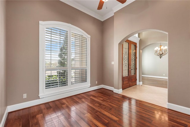 5106 Bellerive Bend Dr, College Station, TX 77845 - foyer featuring crown molding, hardwood / wood-style flooring, baseboards, arched walkways, and ceiling fan with notable chandelier