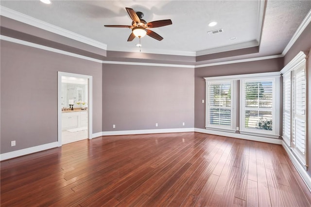 5106 Bellerive Bend Dr, College Station, TX 77845 - empty room featuring visible vents, baseboards, ornamental molding, wood finished floors, and a raised ceiling