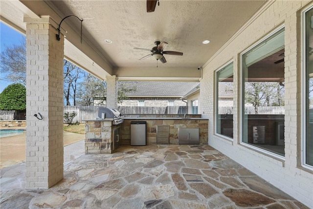 5106 Bellerive Bend Dr, College Station, TX 77845 - view of patio / terrace with a fenced backyard, an outdoor kitchen, grilling area, and a ceiling fan