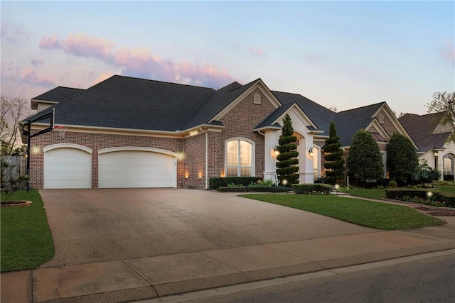 5106 Bellerive Bend Dr, College Station, TX 77845 - view of front facade with brick siding, driveway, a garage, and a lawn