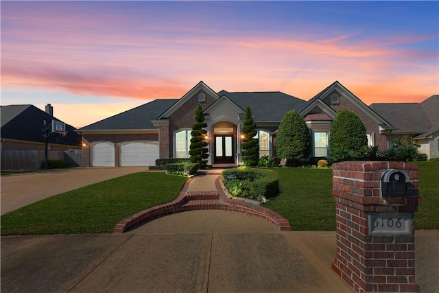 5106 Bellerive Bend Dr, College Station, TX 77845 - view of front of home with fence, an attached garage, driveway, a front yard, and brick siding
