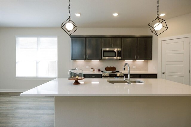 2778 Messenger Way, Bryan, TX 77803 - kitchen with appliances with stainless steel finishes, a sink, light countertops, decorative light fixtures, and recessed lighting