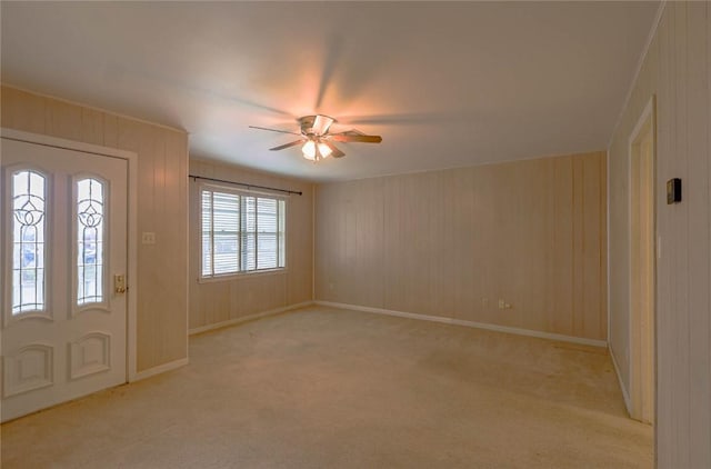 entryway with ceiling fan and light carpet