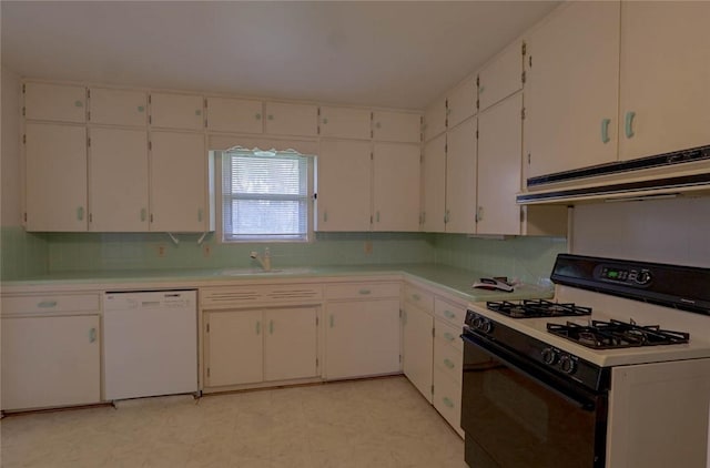 kitchen featuring sink, white appliances, white cabinets, and backsplash