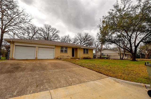 ranch-style house featuring a garage and a front lawn