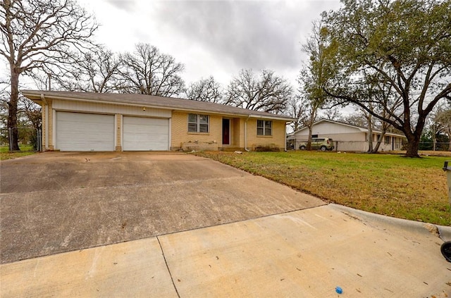 ranch-style house featuring a garage and a front yard