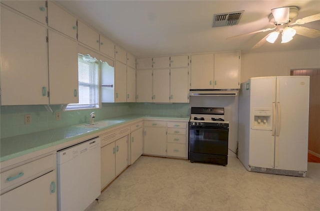 kitchen with white cabinetry, white appliances, and tasteful backsplash