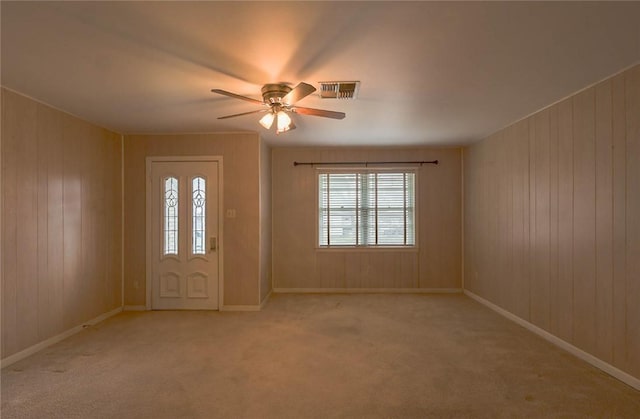 entrance foyer featuring light colored carpet and ceiling fan