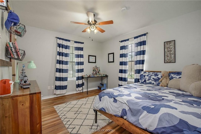 bedroom featuring ceiling fan and hardwood / wood-style flooring