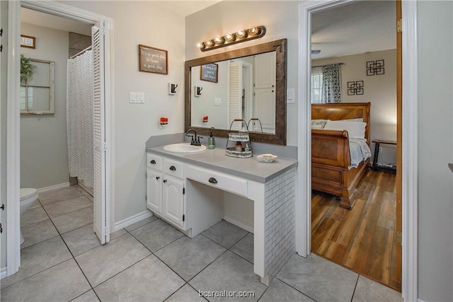 bathroom with hardwood / wood-style flooring, vanity, and toilet