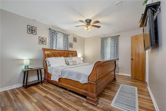 bedroom featuring hardwood / wood-style flooring and ceiling fan