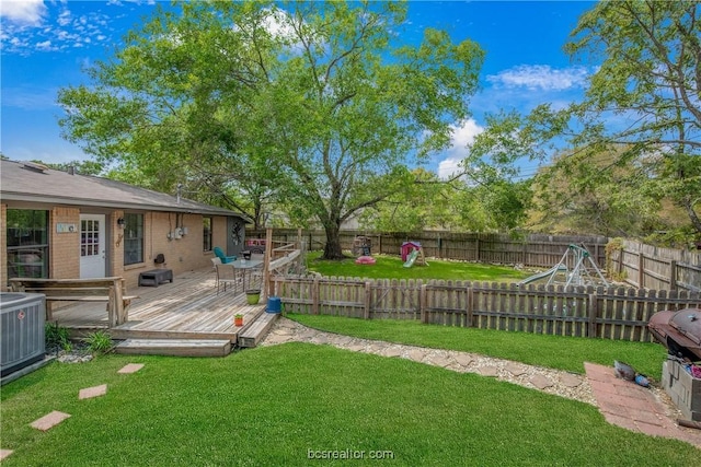 view of yard with central AC unit and a deck