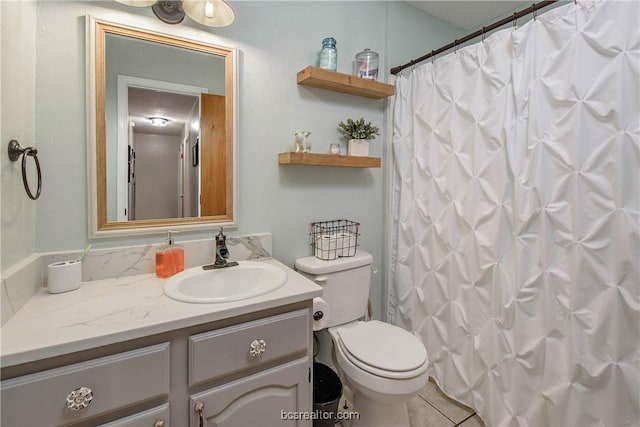 bathroom with walk in shower, tile patterned flooring, vanity, and toilet