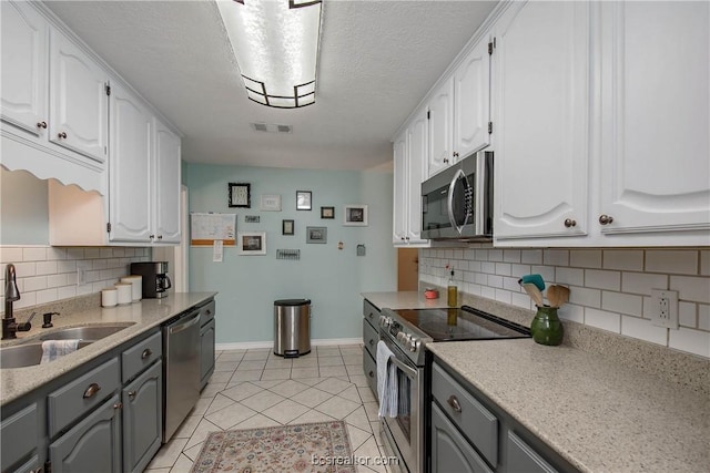 kitchen featuring gray cabinetry, white cabinetry, sink, and appliances with stainless steel finishes