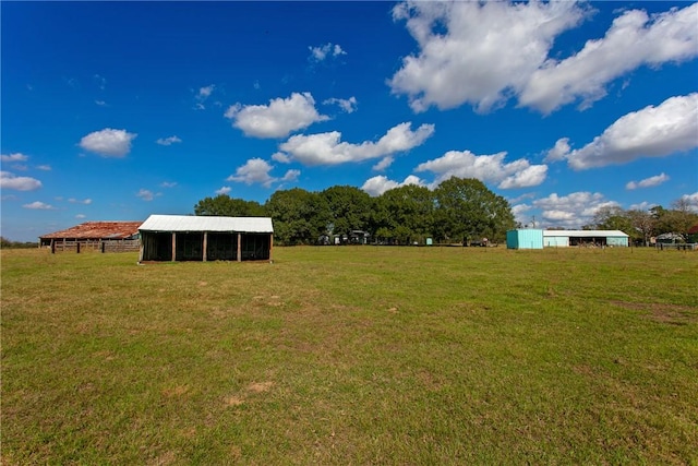 view of yard featuring an outbuilding and a rural view