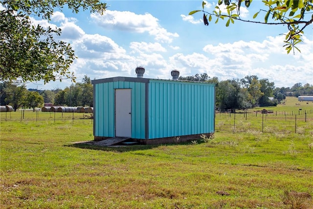 view of outdoor structure featuring a yard and a rural view