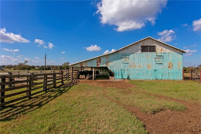 view of outdoor structure with a yard and a rural view