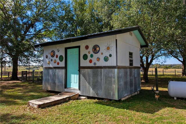 view of outdoor structure featuring a yard and a rural view