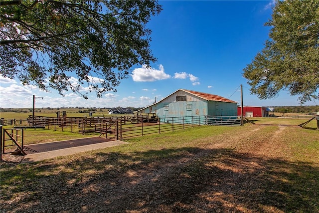 view of yard featuring a rural view and an outdoor structure