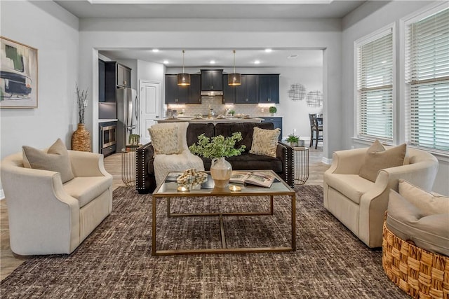 living room with dark hardwood / wood-style flooring