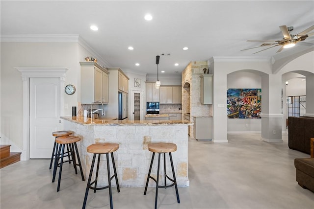 9560 County Road 121, Iola, TX 77861 - kitchen featuring concrete flooring, decorative backsplash, light stone countertops, a kitchen breakfast bar, and a peninsula