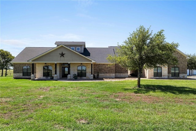 9560 County Road 121, Iola, TX 77861 - view of front facade with a front lawn, a ceiling fan, and stone siding