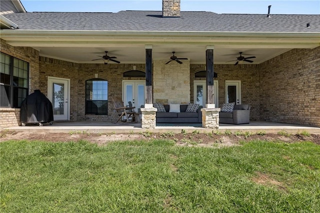 9560 County Road 121, Iola, TX 77861 - back of house featuring a ceiling fan, a shingled roof, brick siding, and a lawn