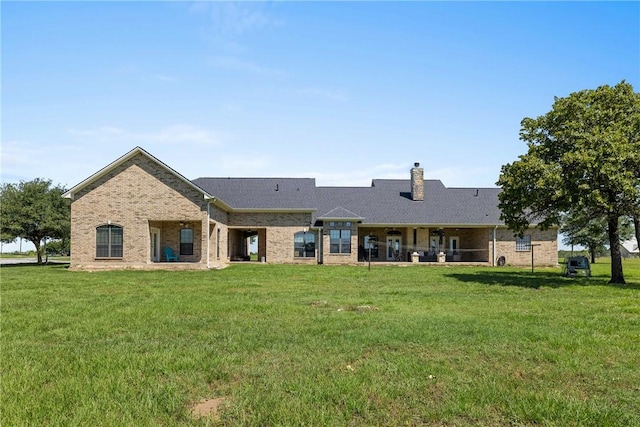 9560 County Road 121, Iola, TX 77861 - rear view of house featuring brick siding, a yard, and a chimney