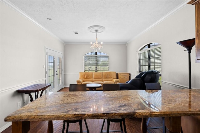 9560 County Road 121, Iola, TX 77861 - dining room featuring healthy amount of natural light, a chandelier, a textured ceiling, ornamental molding, and baseboards