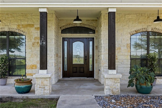 9560 County Road 121, Iola, TX 77861 - view of exterior entry featuring stone siding and a porch