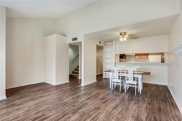 dining room featuring visible vents, baseboards, stairs, wood finished floors, and a ceiling fan