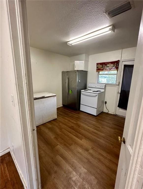 kitchen featuring white cabinetry, dark wood-type flooring, white electric range, stainless steel fridge, and a textured ceiling