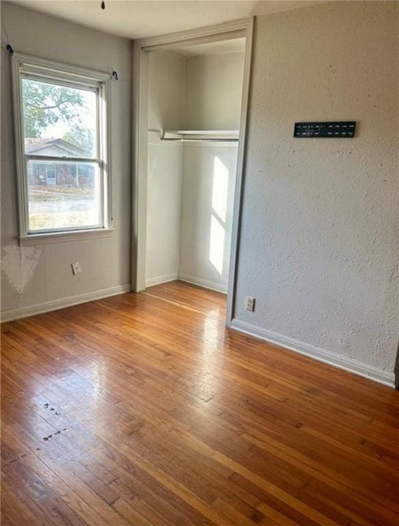 unfurnished bedroom featuring light wood-type flooring and a closet