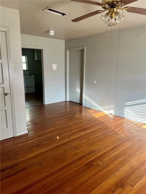 spare room with dark hardwood / wood-style floors and ceiling fan