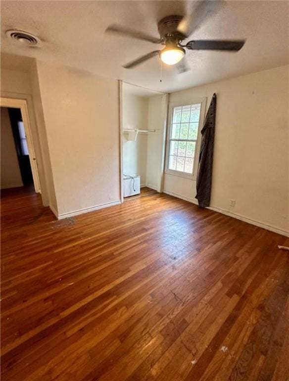 unfurnished bedroom featuring ceiling fan and dark wood-type flooring