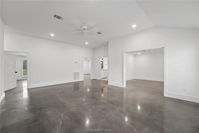 unfurnished living room with ceiling fan and vaulted ceiling