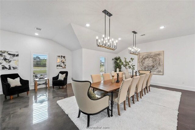 dining area with vaulted ceiling and an inviting chandelier