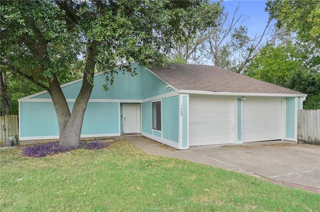 view of front of home featuring a garage, a front yard, and fence