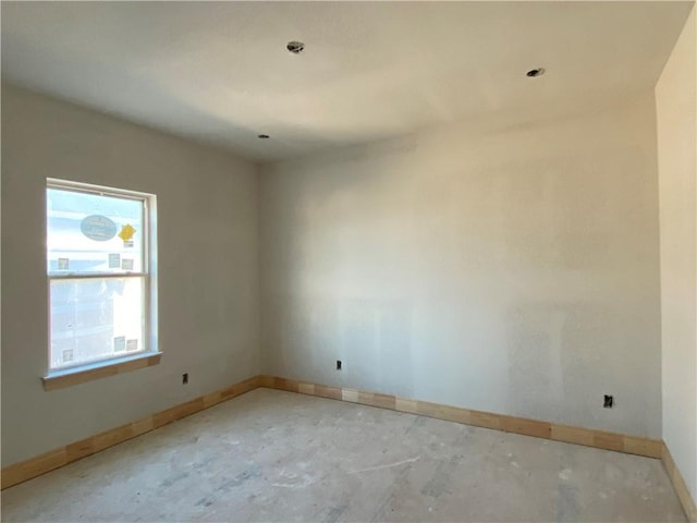 unfurnished room featuring a healthy amount of sunlight and concrete floors