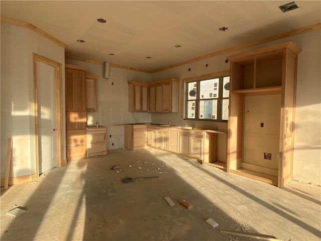 kitchen featuring light brown cabinetry and crown molding