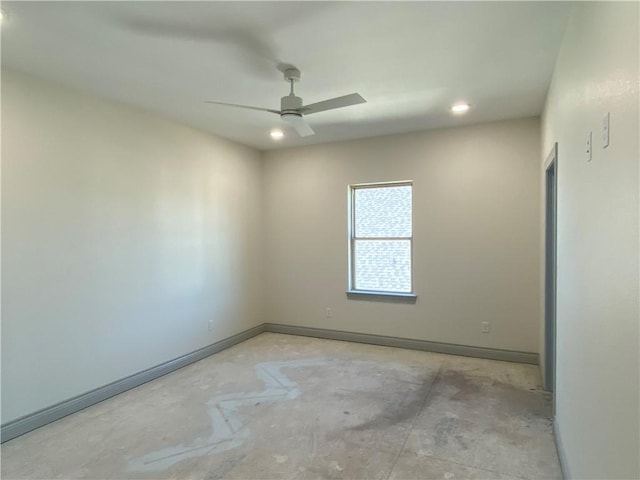 empty room with concrete flooring, ceiling fan, and baseboards