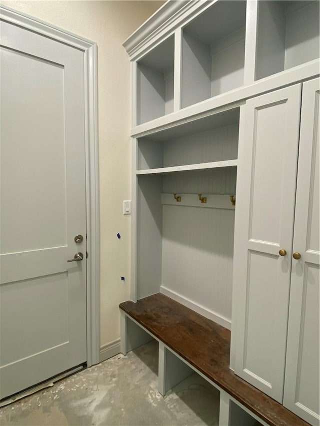 mudroom with unfinished concrete floors