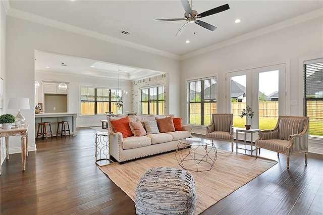 living room with ceiling fan, dark hardwood / wood-style flooring, and ornamental molding