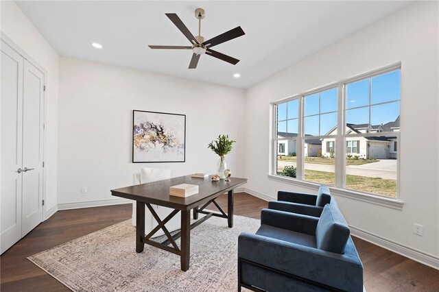 living room with dark hardwood / wood-style flooring, ceiling fan, and crown molding