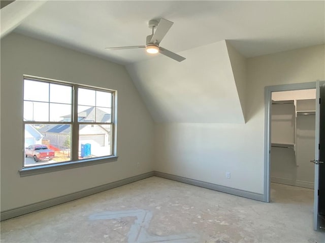 bonus room featuring baseboards, vaulted ceiling, and a ceiling fan