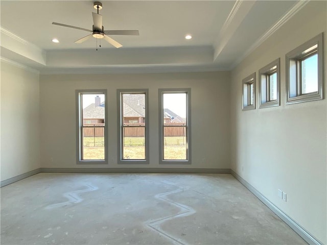 empty room featuring ornamental molding, recessed lighting, a raised ceiling, and baseboards