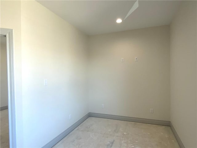 unfurnished room with baseboards