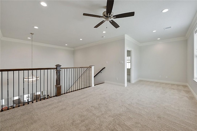 empty room with crown molding, ceiling fan, and light colored carpet