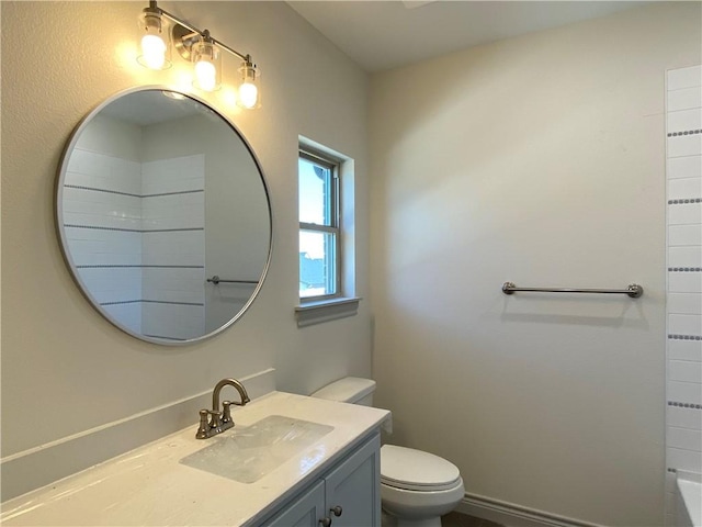 bathroom with walk in shower, vanity, and toilet