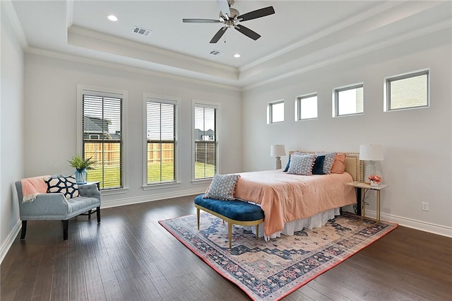 bedroom featuring a raised ceiling, ceiling fan, dark hardwood / wood-style flooring, and ornamental molding